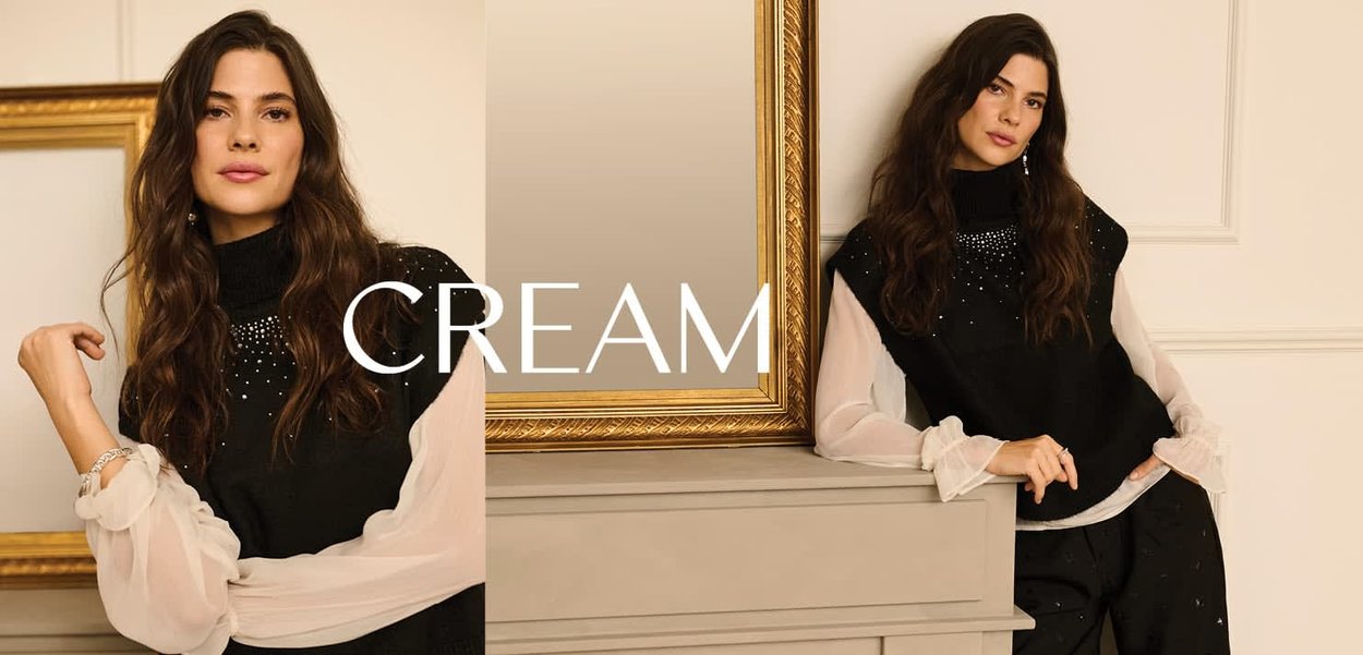 Schwarzes ärmelloses Oberteil mit hohem Ausschnitt und Perlenverzierungen, kombiniert mit weiten weißen, transparenten Ärmeln und schwarzen Hosen. Textüberlagerung: "CREAM."