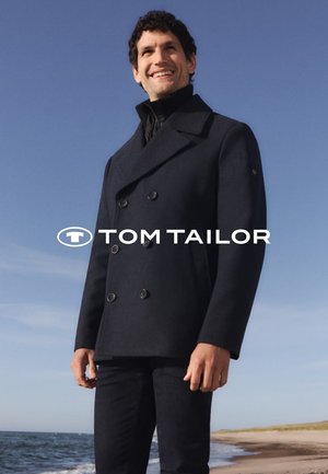 Navy blue double-breasted peacoat with large buttons, made of wool-like material. Smooth texture, notched collar, layered over a black turtleneck.