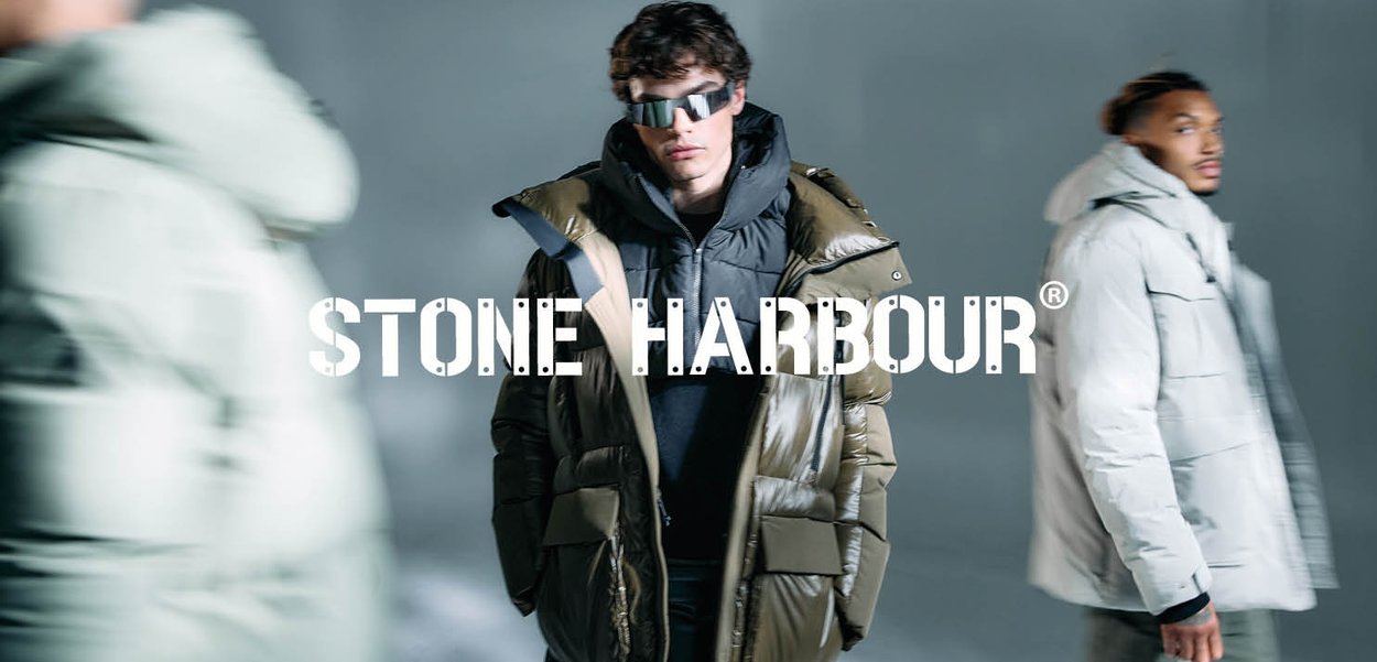Two models wearing puffer jackets. One in olive green with a high collar, the other in light gray. The backdrop is soft-focus gray.