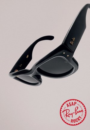 Black Ray-Ban Wayfarer style sunglasses angled against a light background with a red circular ASAP Rocky logo.