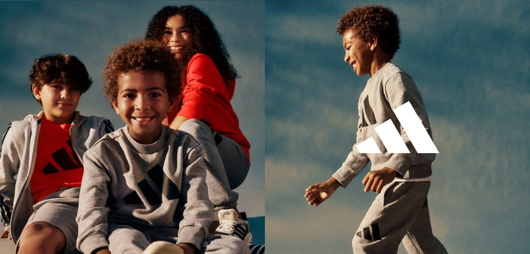 Ropa deportiva gris que incluye un sudadera y pantalones cortos con acentos y logotipo en negro. El fondo muestra un cielo azul y a tres niños en poses relajadas.