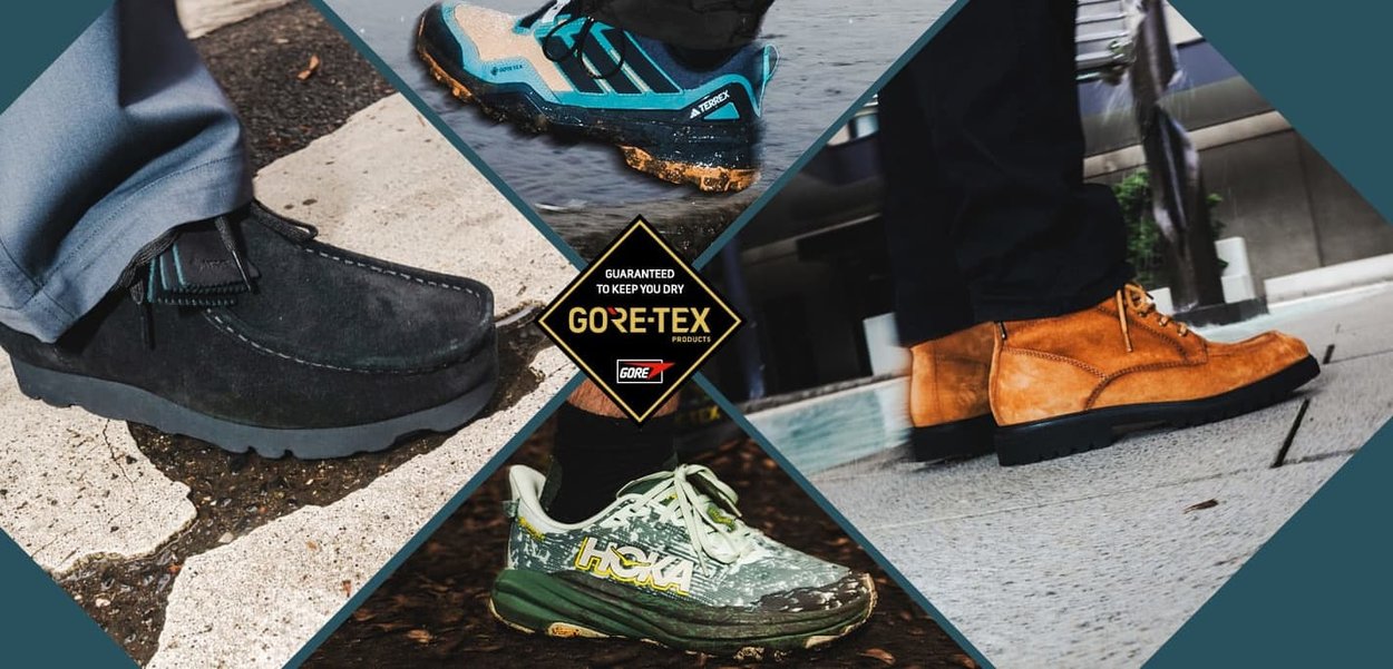 Vier Paare Schuhe: schwarze Wildlederloafer, blau-schwarze Sportschuhe, grün-weiße Trailschuhe und tanfarbene Wildlederstiefel. Alle verfügen über strukturierte Materialien.