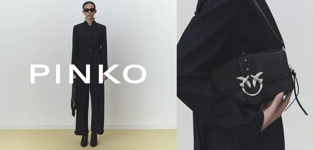 Black tailored suit with a fitted blazer and wide-leg pants. Black handbag with silver bird-shaped hardware and textured accents. Minimalist design.