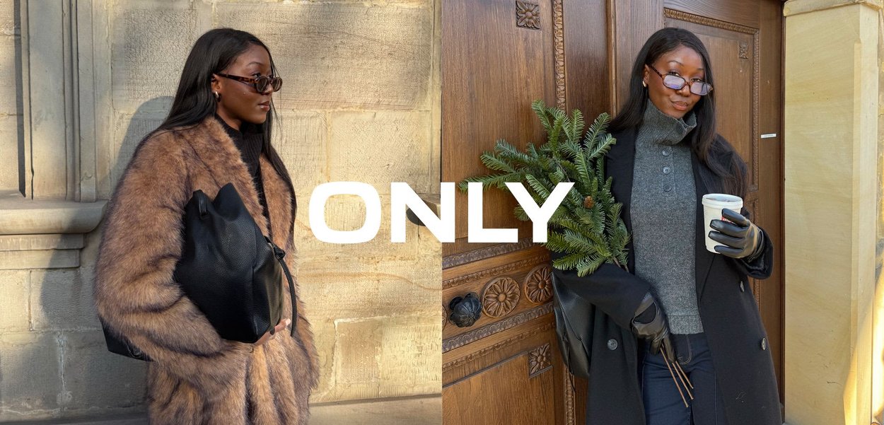 Brauner Mantel aus Kunstpelz mit strukturierter Oberfläche, getragen über einem schwarzen Rollkragenpullover. Hält eine schwarze Lederhandtasche mit weicher, genarbter Textur.