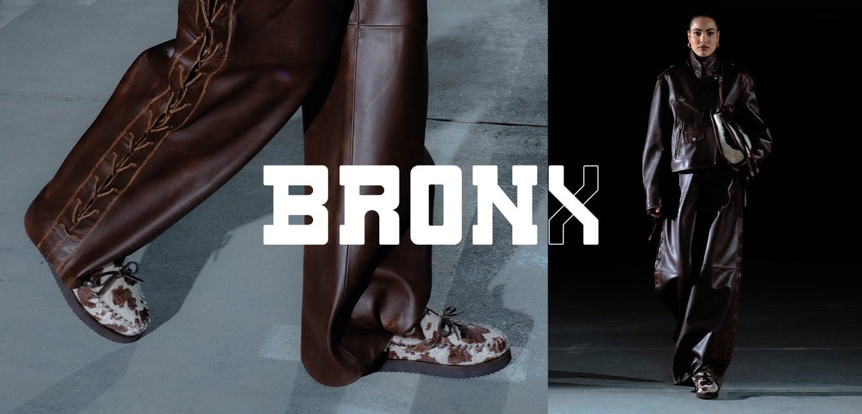 Brown leather pants with a side braid detail, paired with brown and white fuzzy shoes. Bold "BRONX" text overlay at the bottom.