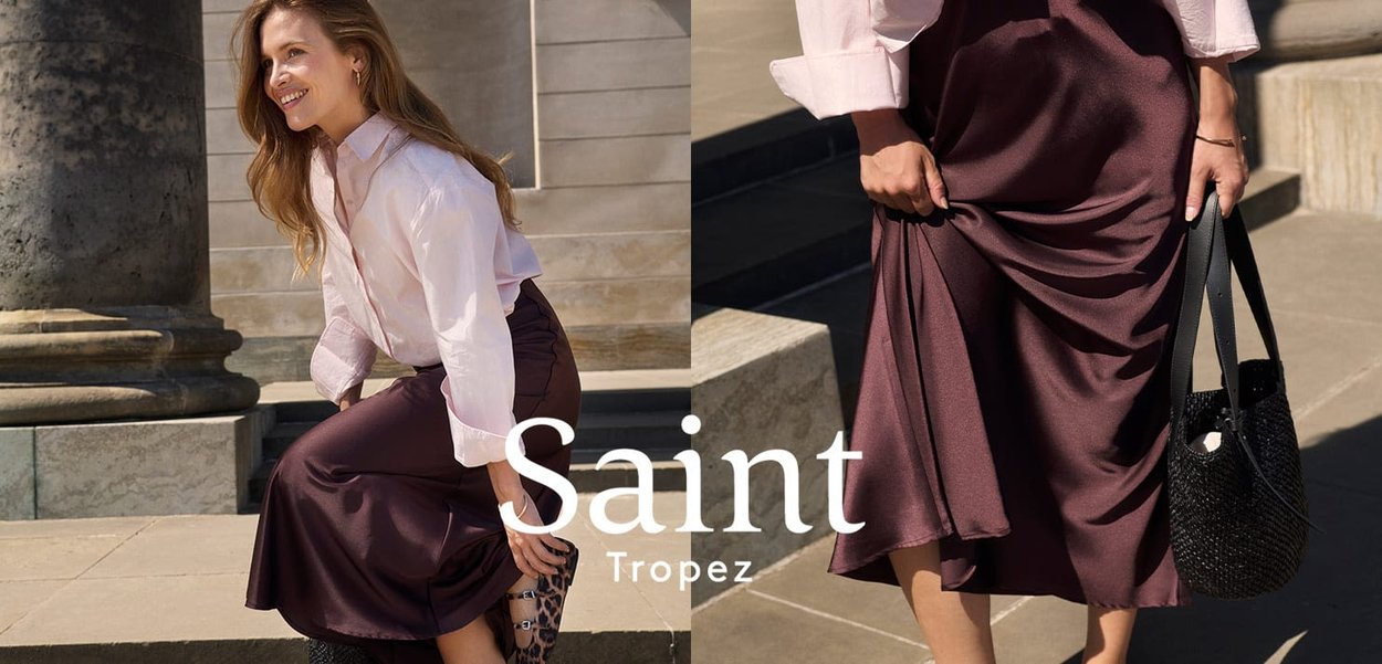 Gonna midi in satin di un ricco bordeaux abbinata a una camicia rosa chiaro con bottoni. Include una borsa nera trapuntata. Tessuto liscio e fluido.