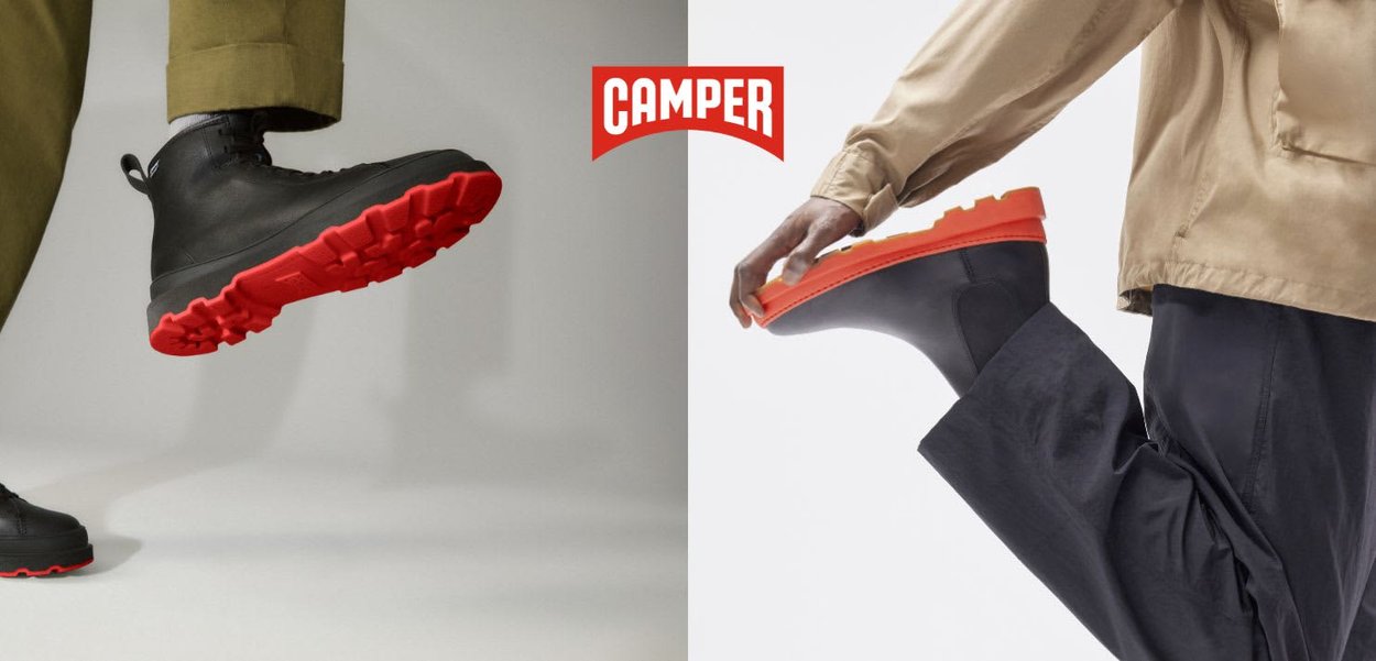 Zwei Personen tragen schwarze Stiefel mit leuchtend roten Sohlen, eine tritt nach unten und die andere beugt das Knie, das Camper-Logo ist mittig darüber platziert.