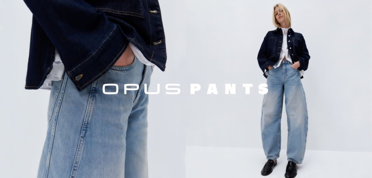 Light blue denim pants with a relaxed fit, featuring a high waist, wide legs, and subtle fading. The design includes pockets and stitching details.