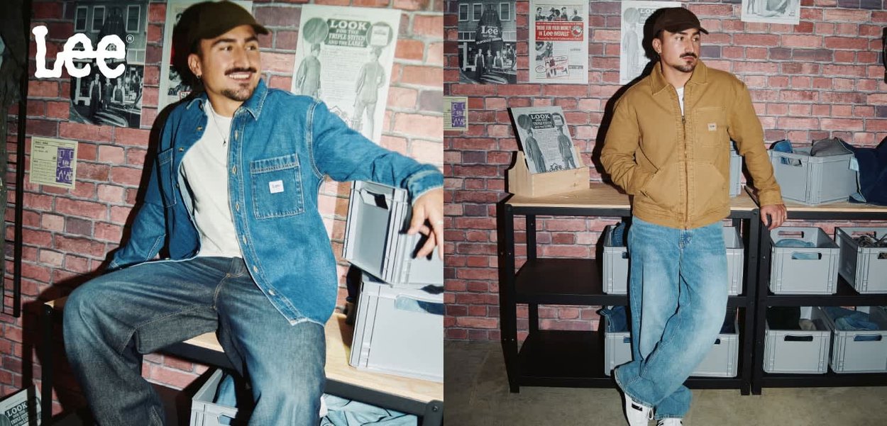Denim and brown worker jacket worn with light blue jeans; brick wall backdrop with storage boxes and vintage posters. Text: "Lee."