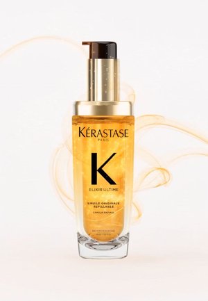 Huile capillaire Kérastase Elixir Ultime dans une bouteille en verre transparent. Liquide doré, design cylindrique élégant, pompe noire et accents dorés.