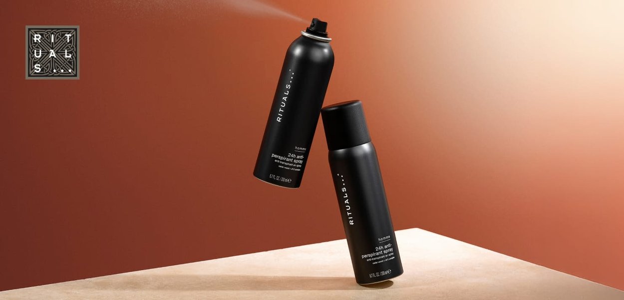 Black aerosol and bottle of antiperspirant spray with minimalistic design. Text on labels includes "Rituals" and product details.