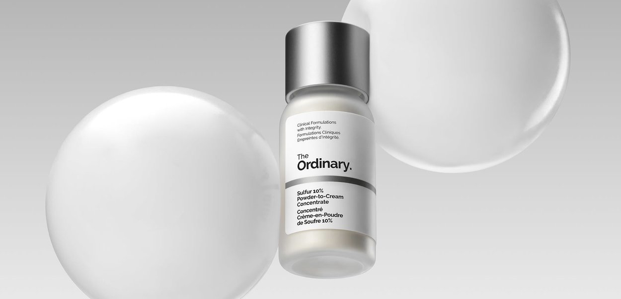 Small frosted glass bottle with silver cap, labeled The Ordinary Sulfur 10% Powder-to-Cream Concentrate in black text on white background.