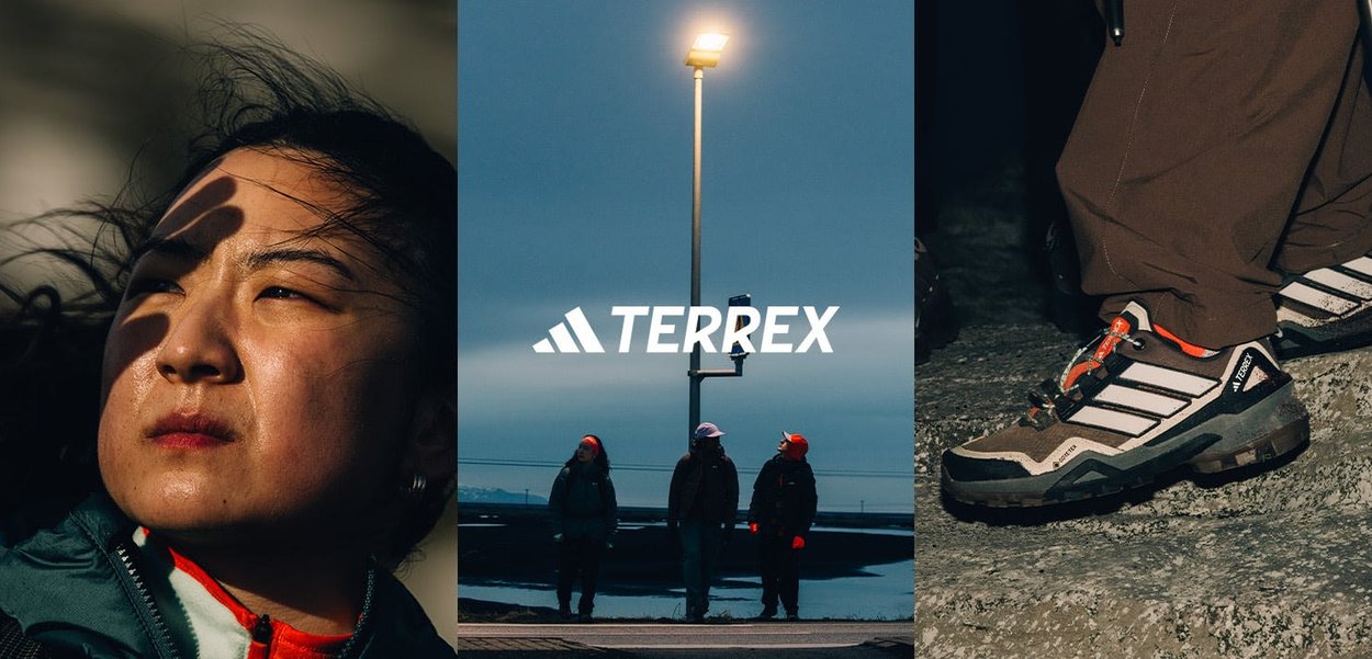 Terrex footwear features a sturdy, textured gray and brown design with white stripes and vibrant accents, suitable for outdoor conditions.