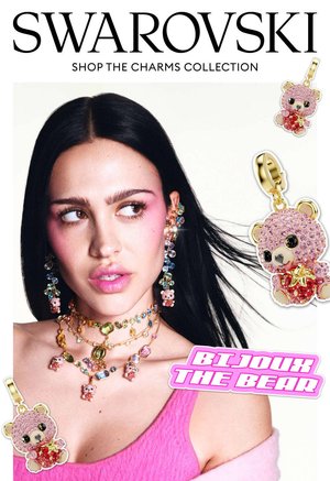 Vrouw met donker haar die kleurrijke oorbellen met kristallen berenbedels en gelaagde kettingen draagt, ter promotie van de Bijoux the Bear-collectie van Swarovski.