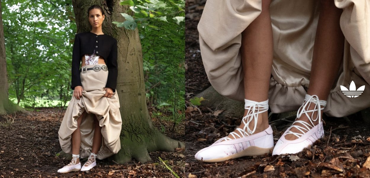 White lace-up shoes with a soft pink hue, featuring a rounded toe and textured sole, paired with a flowing beige skirt and black jacket.