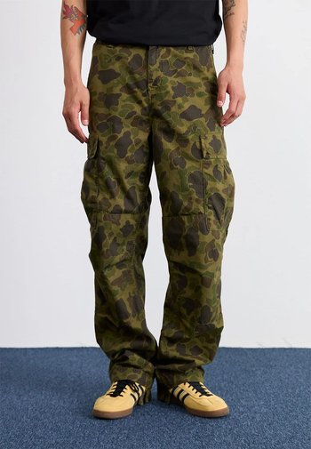 Camo cargobroek in groene tinten, met zijzakken, een comfortabele pasvorm en een stevige stof. Draag met gele sneakers.