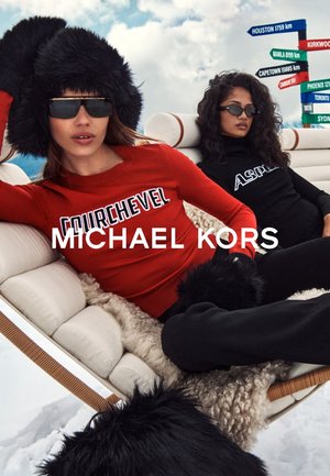 Top rojo de manga larga con el texto "COURCHEVEL", combinado con un top negro que muestra "ASPA"; ambos modelos llevan sombreros peludos y gafas de sol, sentados en un sofá blanco.