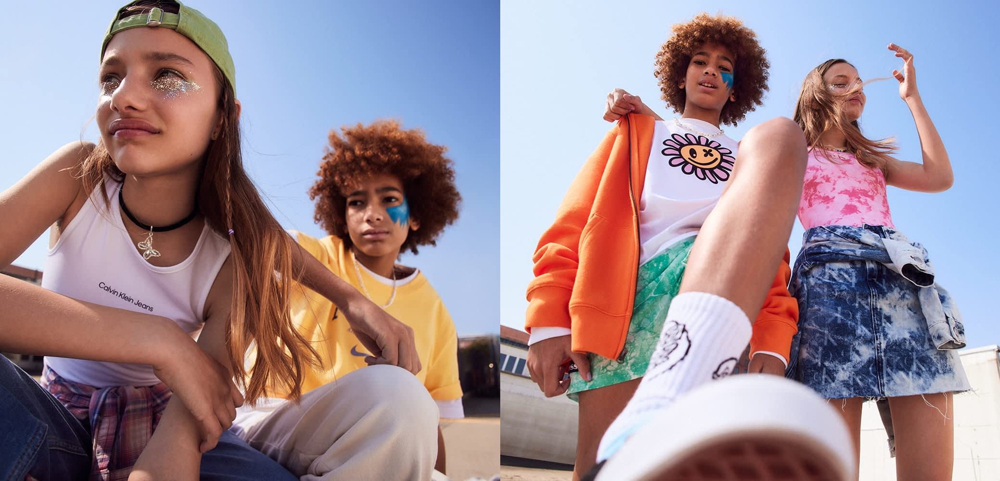 Deux enfants portent des tenues décontractées d'été : un débardeur blanc, un sweat à capuche orange et une jupe en denim avec un motif tie-dye. Cadre en extérieur, ciel bleu.