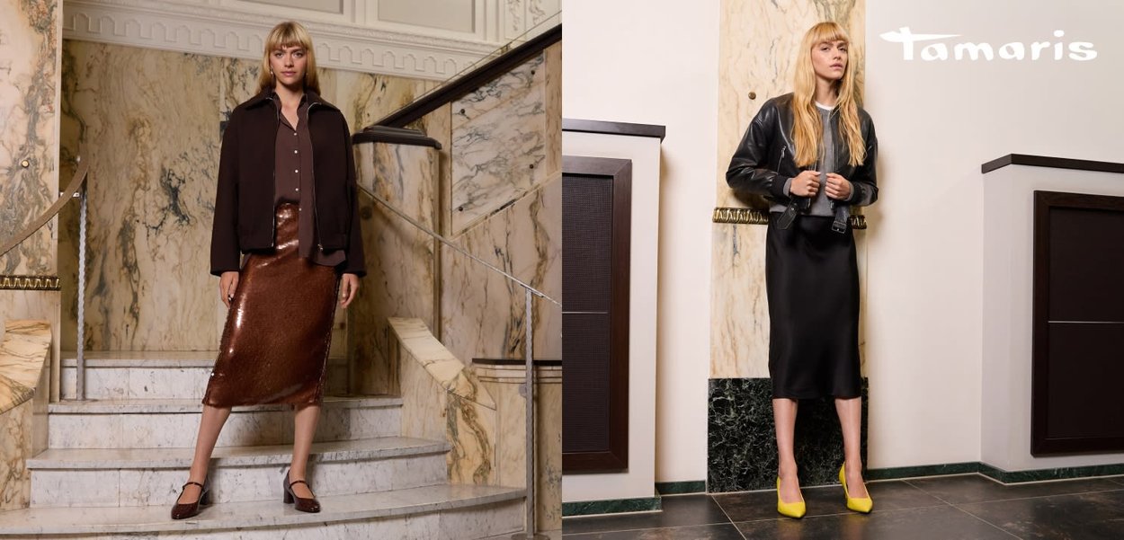Two women in stylish outfits: one in a brown shirt and metallic skirt, the other in a black jacket over a long black dress with yellow heels.