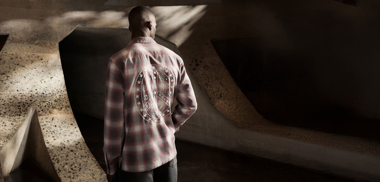 Chemise à boutons en tartan dans des tons rose et gris, ornée d'un grand motif de symbole de la paix au dos, fabriquée dans un tissu doux avec une finition texturée.