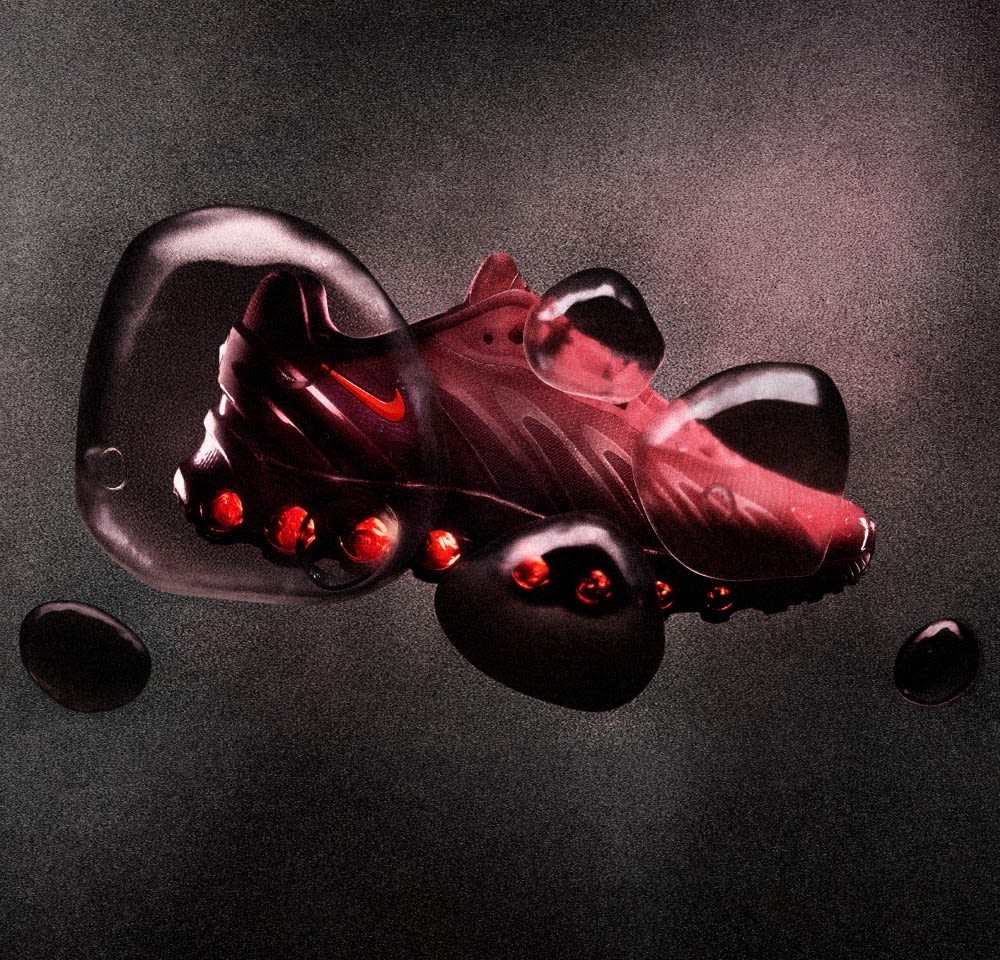 Nike-schoen met een slank rood bovenwerk met een gestructureerd ontwerp en zichtbare luchtkussens. Ronde zool met zwarte accenten en glanzende details.