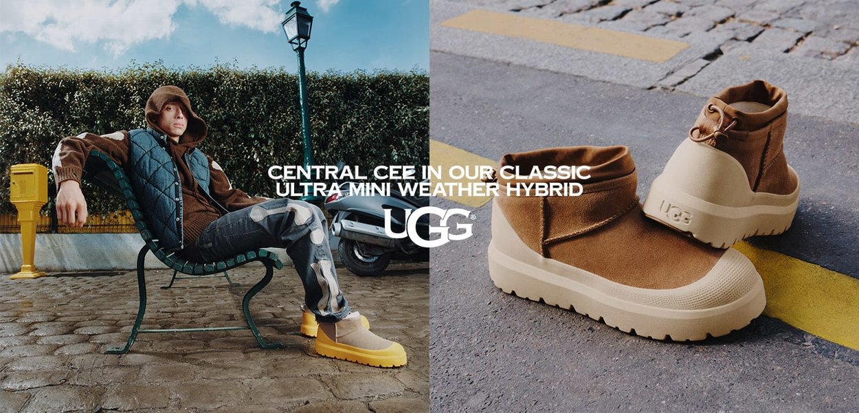 Personne portant des bottes UGG Central CEE marron et jaune assise sur un banc à l'extérieur, avec un gros plan sur les bottes sur l'asphalte à côté d'une ligne jaune.