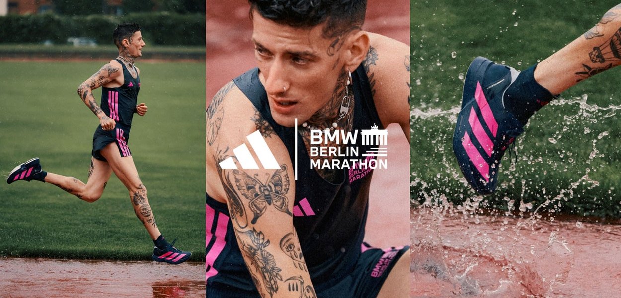 Die Adidas Laufschuhe haben einen dunkelblauen Körper mit auffälligen pinken Streifen. Die Textur ist glatt, geeignet für nasse Bedingungen, und verbessert den Grip.
