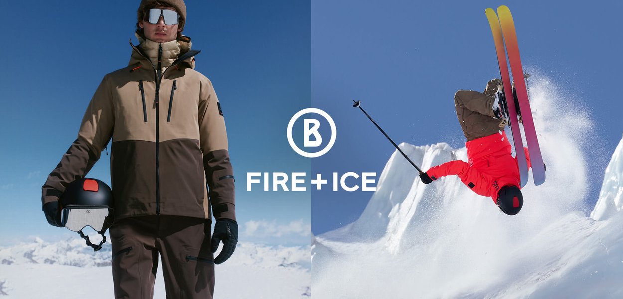 Pánské lyžařské oblečení zahrnuje dvoubarevnou hnědo-béžovou bundu se zipy a černou přilbu, zatímco lyžař v červené bundě provádí skok.