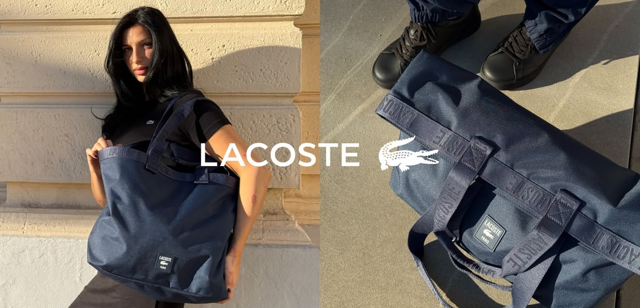 Marineblaue Canvas-Tragetasche mit doppelten Griffen, die das Lacoste-Logo und einen strukturierten Stoff aufweist. Große Kapazität mit externem Branding-Detail.