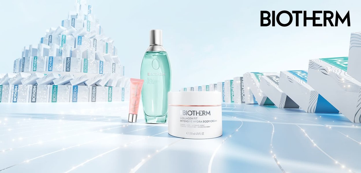 Biotherm Hautpflegeprodukte: eine grüne Glasflasche, eine rosa Tube und ein weißes Glas mit minimalistischen Designs und klaren Etiketten, vor einem hellen Hintergrund.