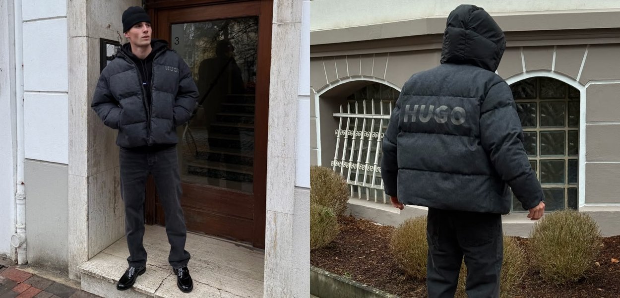 Chaqueta negra acolchada con capucha, que presenta un logo prominente en la espalda. Se lleva con pantalones oscuros y zapatos negros brillantes.