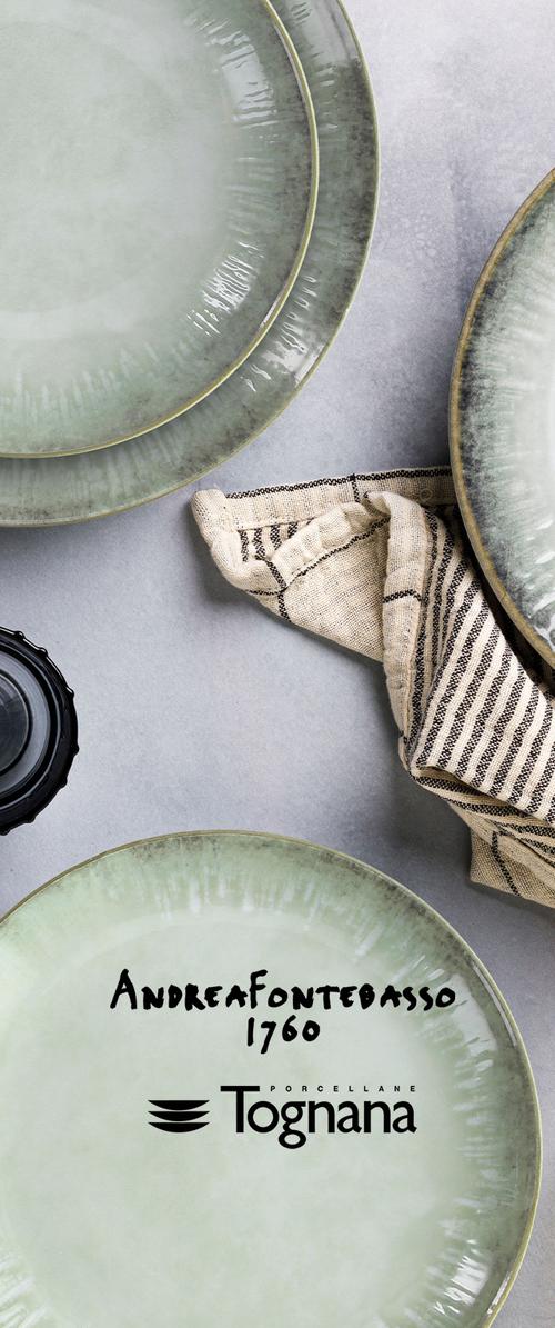 Piatti ceramici verde chiaro con finitura lucida e bordo testurizzato, accompagnati da un tessuto in lino a righe e un oggetto rotondo nero.