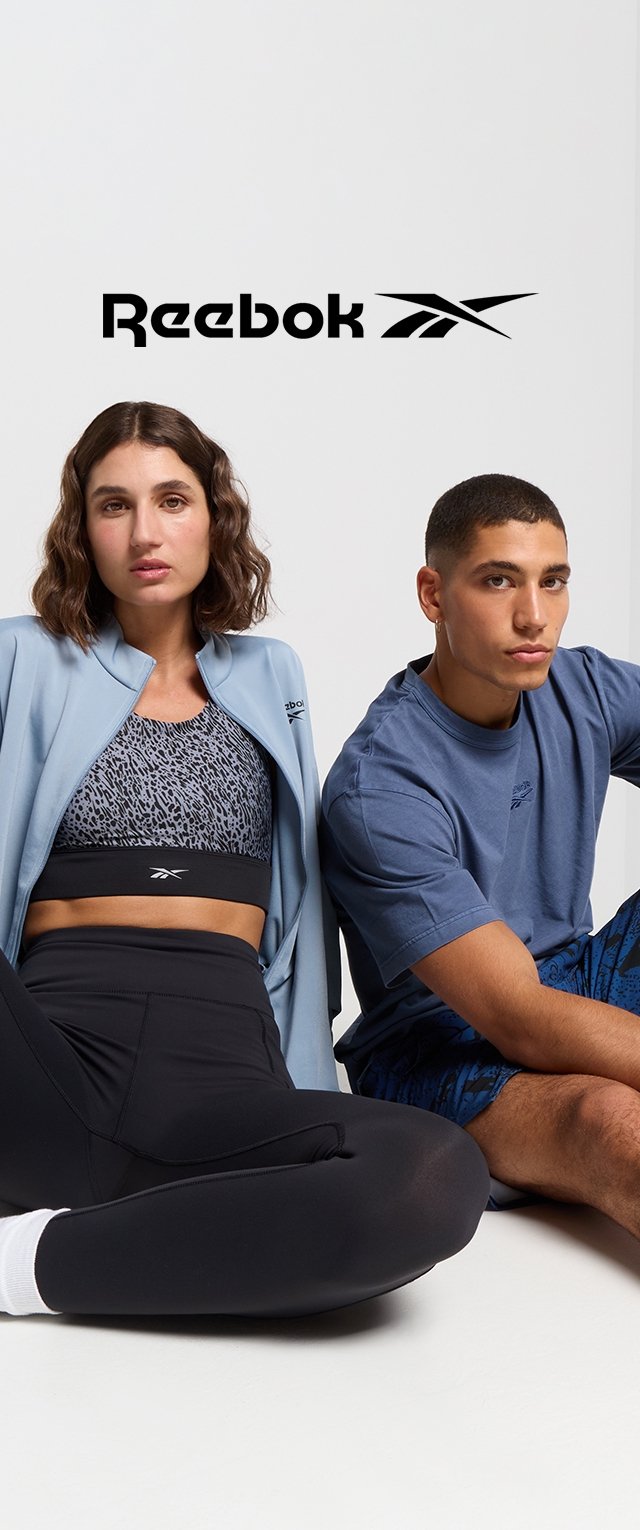 La ropa de Reebok incluye una chaqueta de color azul claro, leggings negros y un sujetador deportivo con un diseño estampado. El modelo masculino lleva una camiseta azul y pantalones cortos con un patrón.