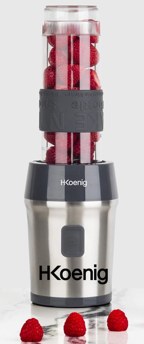 HKoenig blender met een roestvrijstalen basis, doorzichtige container gevuld met rode frambozen en een zwarte gripband voor gemakkelijke hantering.