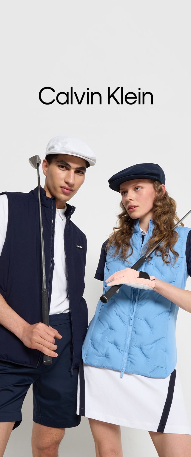 Navy and blue golf attire featuring a zippered puffer vest, polo, and shorts. Golf clubs held by two people against a plain background.
