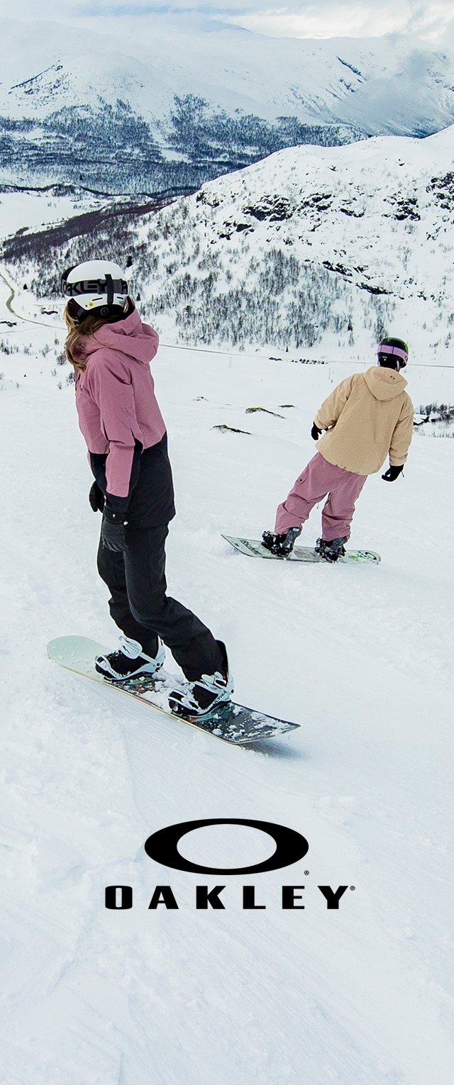 Snowboarders descend a snowy slope, wearing an olive green helmet, black gloves, and outfits in light pink and beige colors with various textures.
