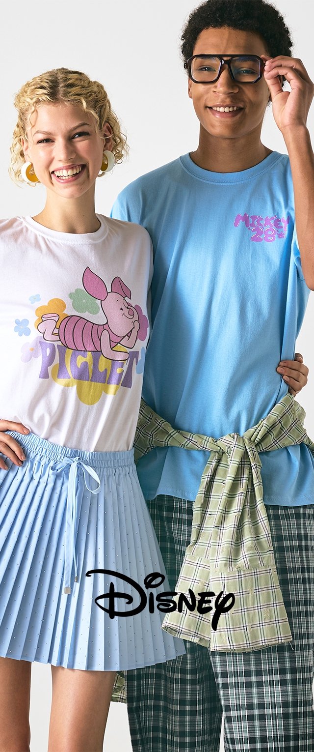 White t-shirt with colorful "Piglet" graphic, paired with a pleated light blue skirt. Blue t-shirt with "Mickey 28" in pink, plaid pants with green accents.