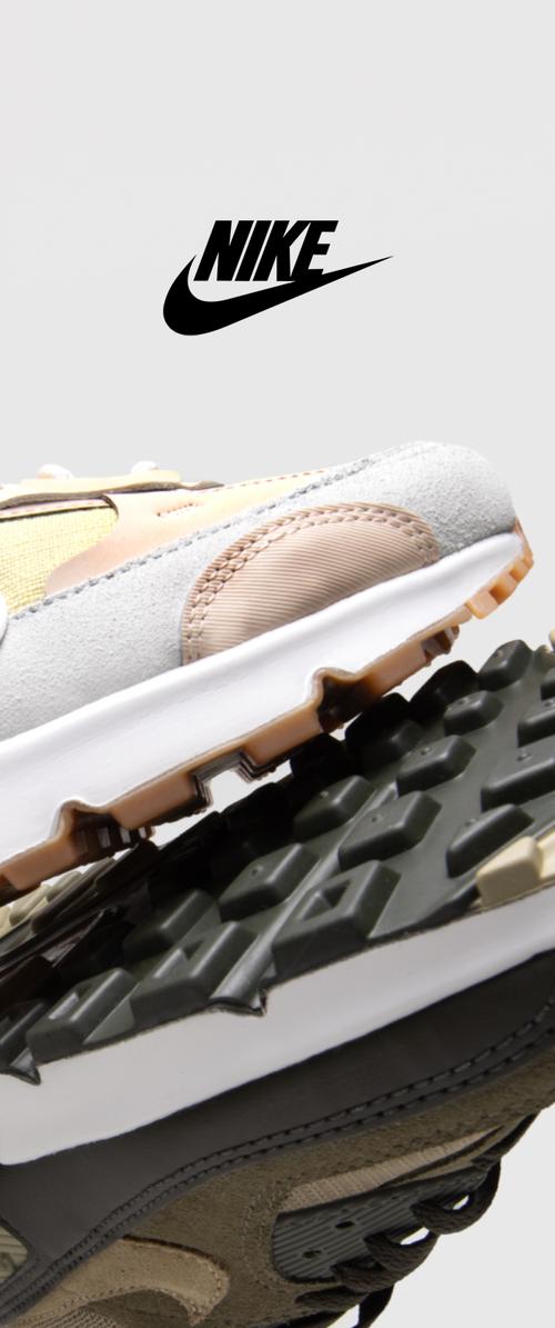 Zapatillas Nike con una parte superior de ante gris, acentos en beige, una entresuela blanca y una suela de goma texturizada en negro y marrón.