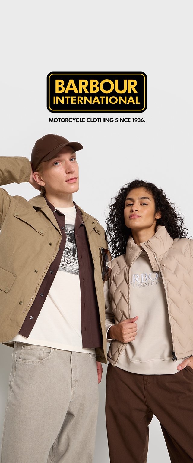 Tan jacket, brown cap, and beige quilted vest with logo; model wears light T-shirt and brown pants. Neutral color palette, casual design.