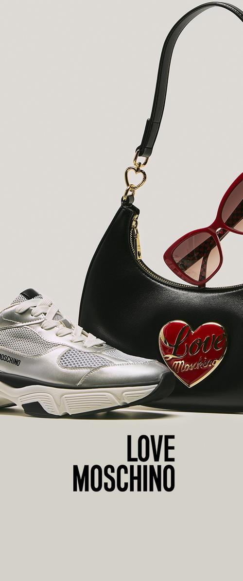 Silver sneakers with mesh panels, a black handbag featuring a red heart logo, and red sunglasses with a patterned interior.