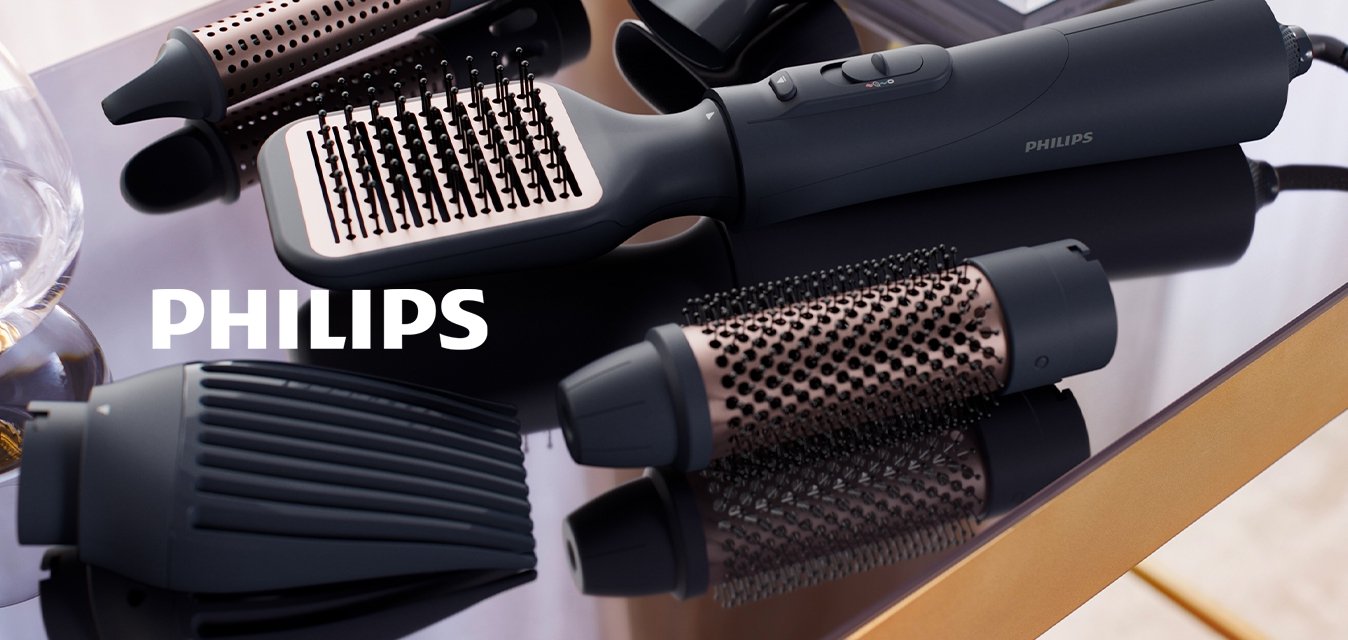 Nástroj na úpravu vlasů s černým ergonomickým tělem, několika vyměnitelnými nástavci v černé a růžově zlaté barvě, s texturovanými povrchy a otvory.