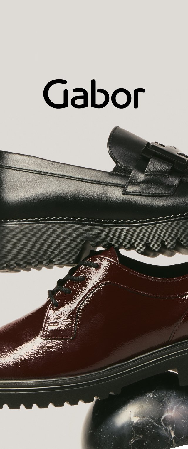 Mocasín negro de cuero con hebilla apilado sobre zapato con cordones de charol rojo oscuro, sobre una esfera de mármol negro, con el logo de Gabor arriba.
