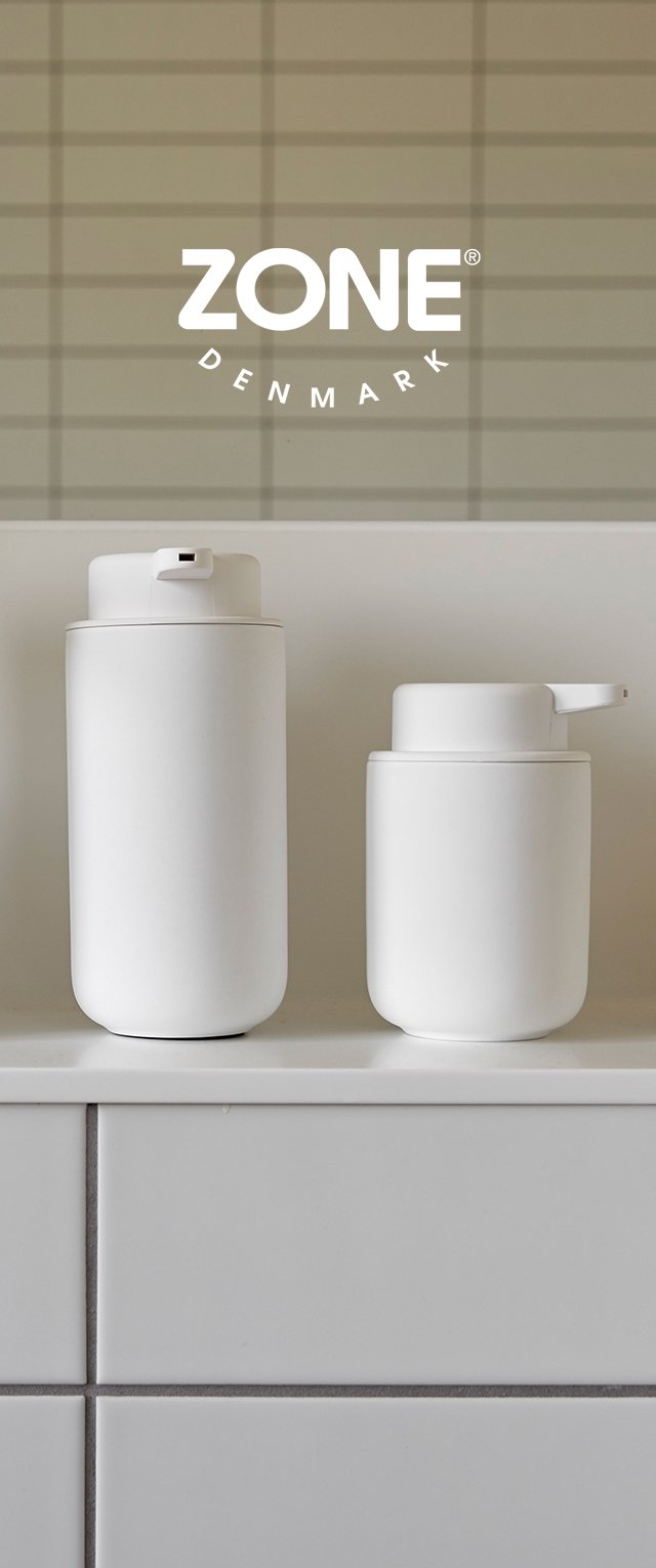 Deux conteneurs cylindriques blancs en matériau lisse ; l'un a un couvercle à rabat, l'autre a un bec verseur. Design simple et minimaliste.