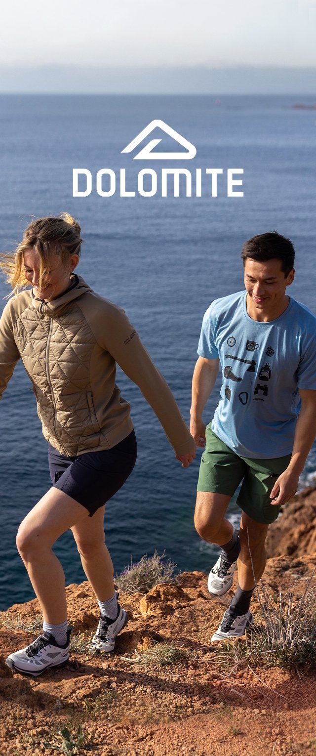 Outdoor apparel featuring a beige quilted jacket and black shorts, alongside a blue t-shirt and green shorts. Both wear light hiking shoes.