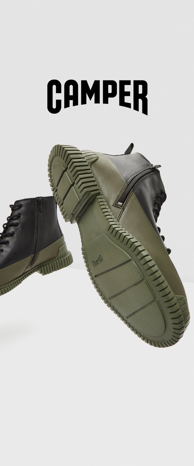 Botas camperas con un upper negro, suela de goma verde, diseño con cordones y un zip lateral para un fácil acceso. Suela con agarre texturizado.