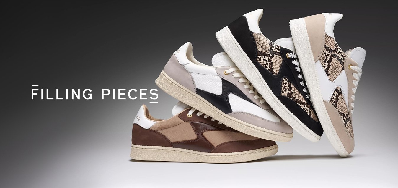 Čtyři páry tenisek v různých barvách: bílé, černé, hnědé a vzorované. Materiály zahrnují kůži a semiš s kontrastními akcenty a texturami.