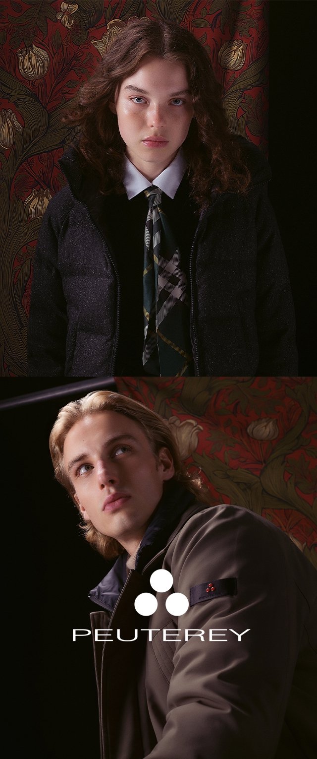 Two individuals wearing jackets: one in a dark puffer with a patterned tie, the other in a light brown coat with a navy collar. Floral backdrop.