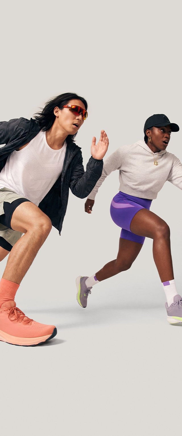 Two athletes in activewear sprinting forward, one wearing a black jacket and orange shoes, the other in purple shorts and a black cap.