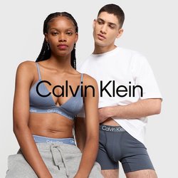 Šedé tepláky a modrý podprsenkový top s tenkými ramínky, doplněné bílým tričkem a šedými trenýrkami, vystavené na světlém pozadí.